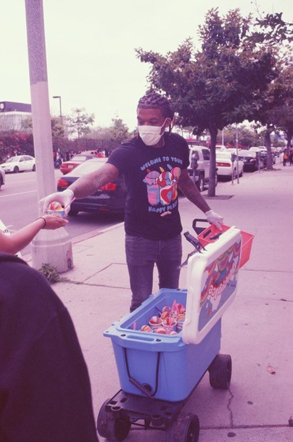 Lemeir Mitchell handing out water ices from Happy Ice during the Black Lives Matter protest in Los Angeles