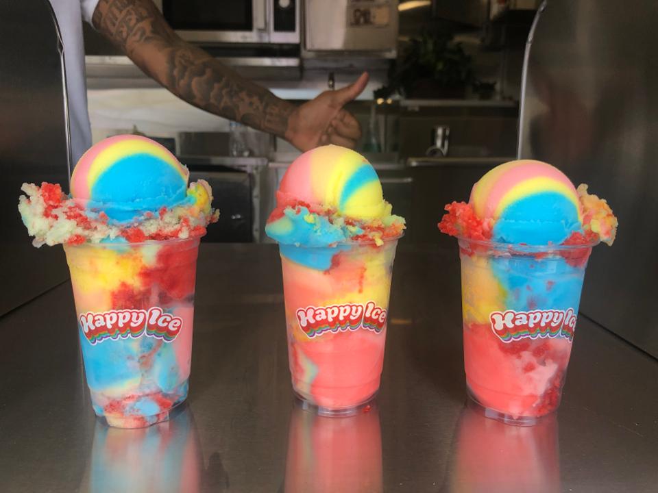 happy ice's rainbow rocket water ices with a thumbs up from a hand in the background