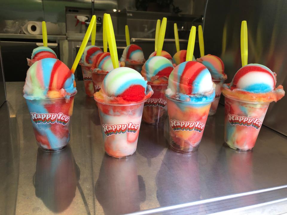 a group of rainbow rocket water ices from happy ice on a counter