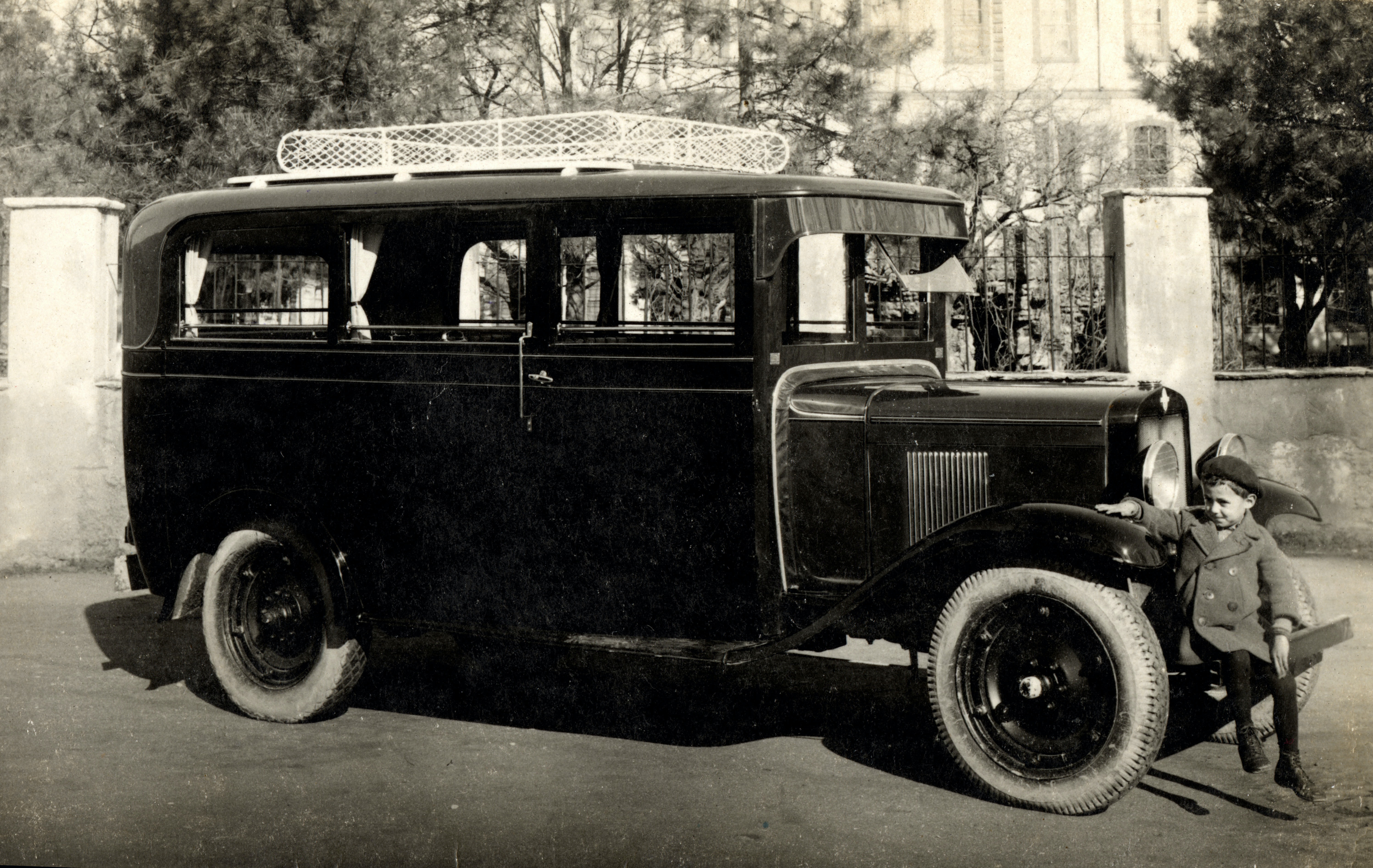 Little Boy Sitting on Bumper of Early RV. Image shot 1915. Exact date unknown.