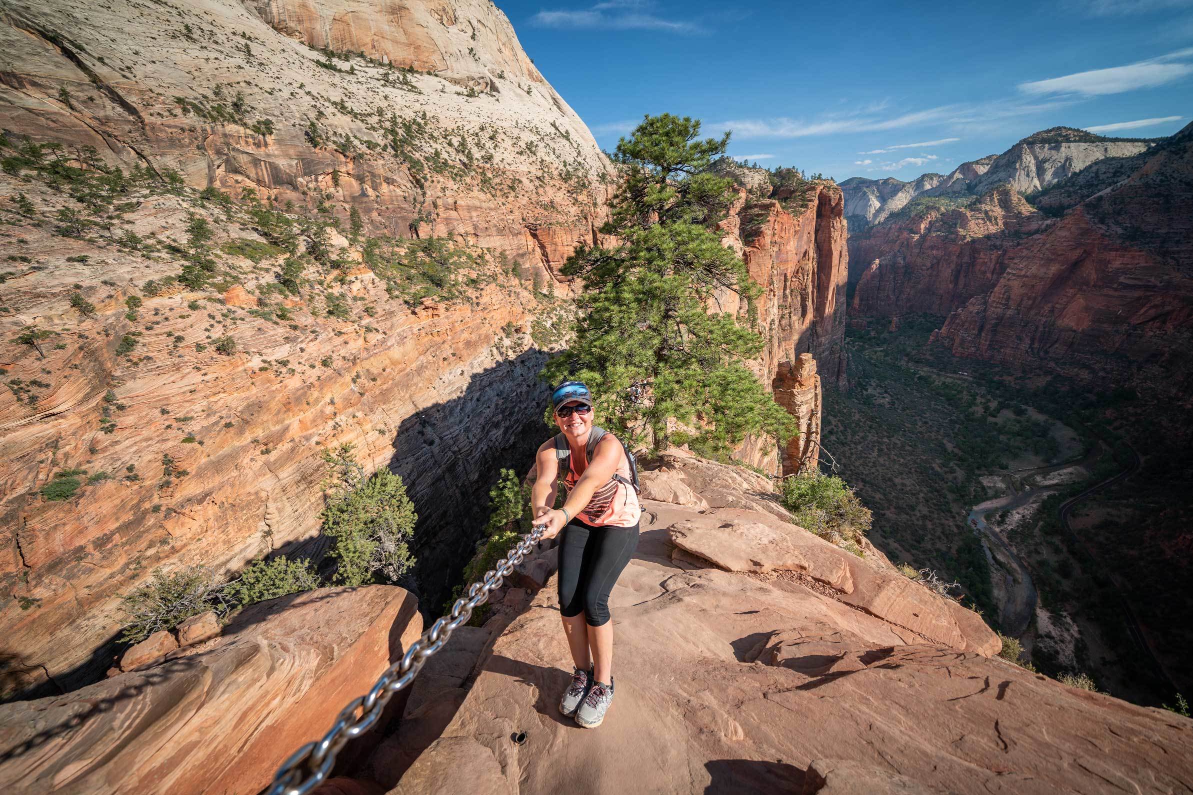 15 June, 2018: A woman holding on to a chain while climbing to the top of Angels Landing.