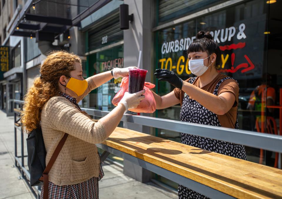 Woman Wearing Homemade Mask Picks Up Food at Restaurant During Covid-19 Lockdown