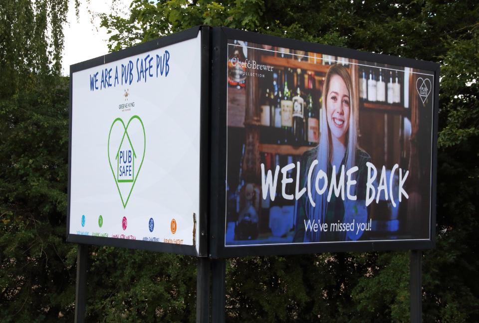 A Welcome Back, Pub Safe scheme sign is displayed in the entrance of one of the pubs in the scheme across the U.K. as pubs reopen after lockdown