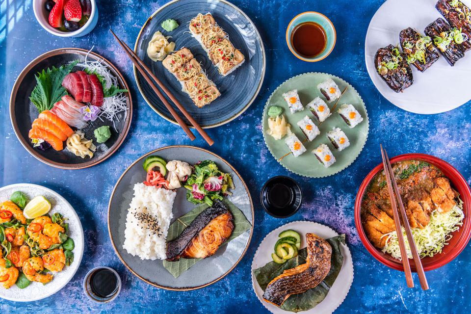 Japanese food dishes on blue background